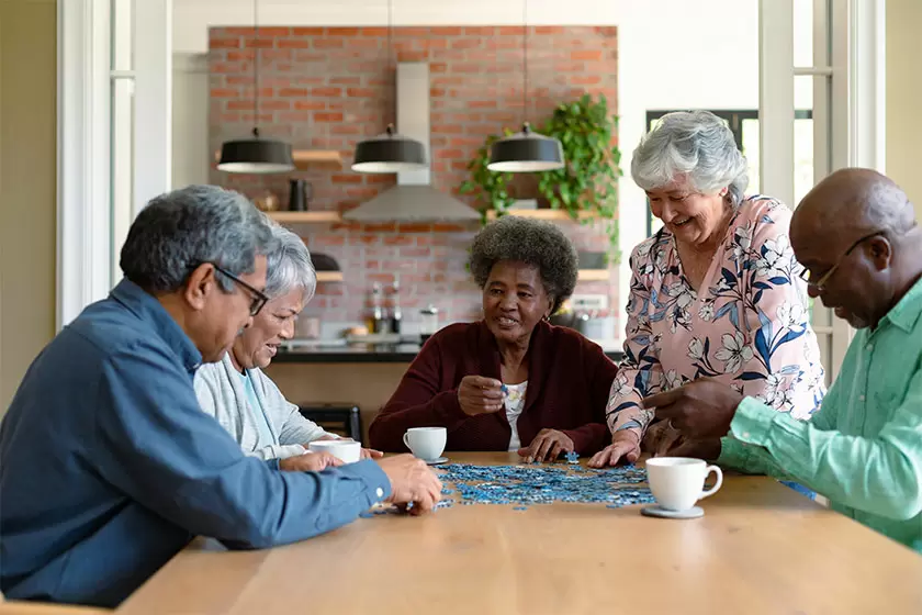 group-diverse-senior-male-female-friends-doing-puzzles